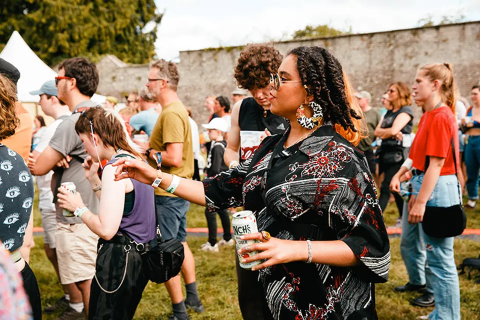 The crowd dance to the music in the walled garden