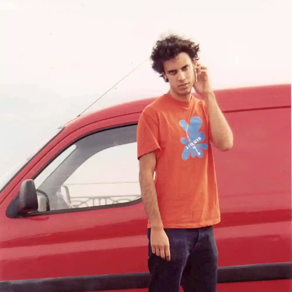 fourtet in front of a red van