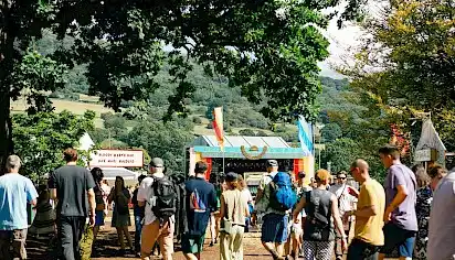People walking around Green Man festival with trees and food stalls