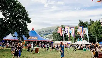 Babbling Tongues area, there is the Babbling Tongues tent which is a large blue and red circus style tent, the Babbler's Bar and large multicoloured festival flags
