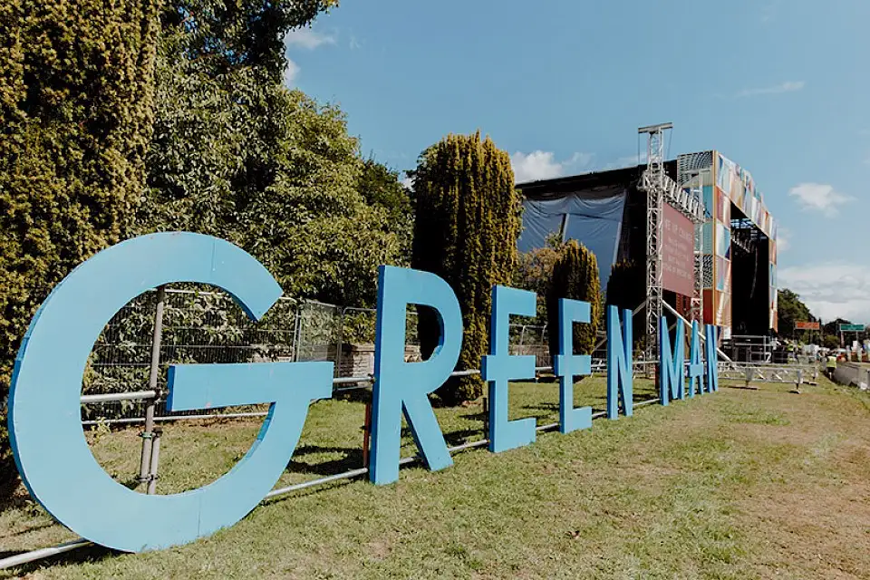 Large letters to the side of the mountain stage spelling out 'Green Man'