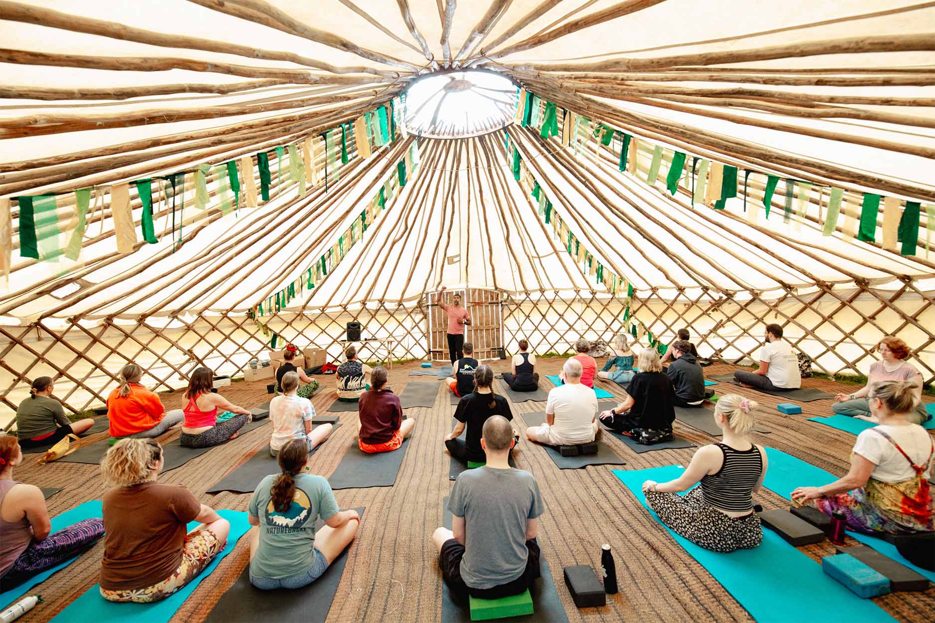 a group doing yoga in a tent