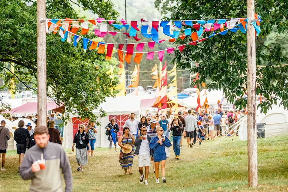 people exploring nature nurture, there is brightly coloured bunting overhead