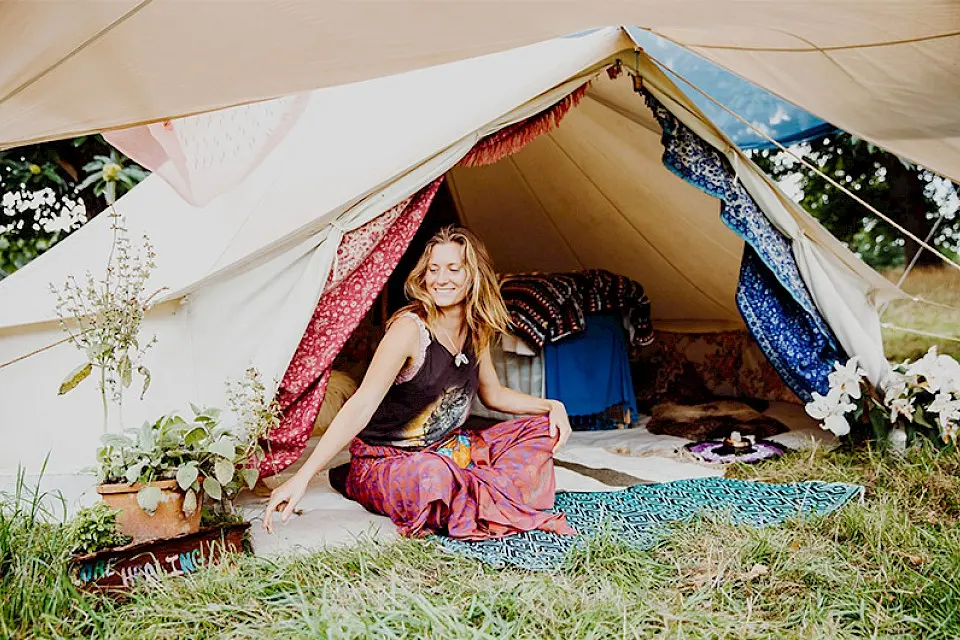 a women sits in the entrance to a tent