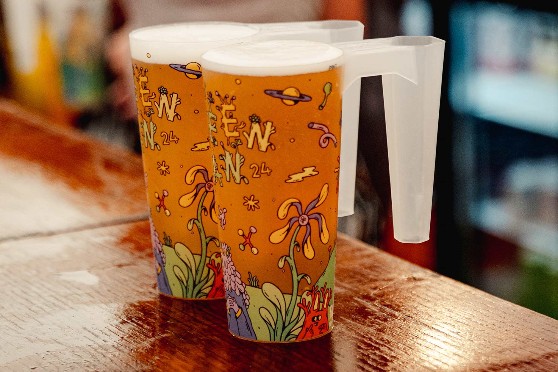 two pints of green man's growler in brightly designed cups