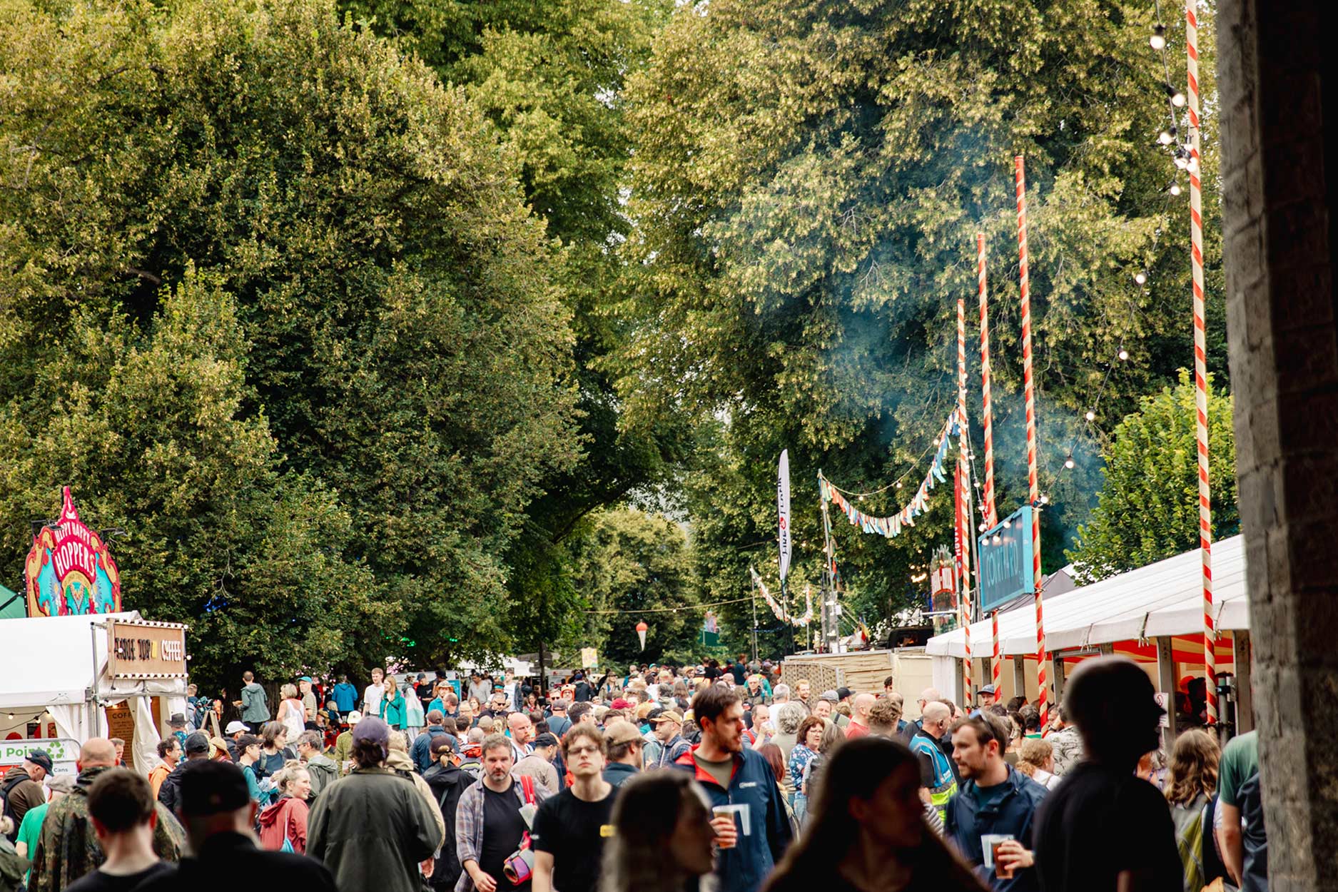 bustling crowds walking through the courtyard archway