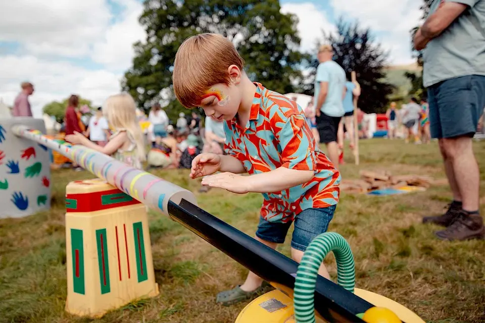 a child with facepaint is playing