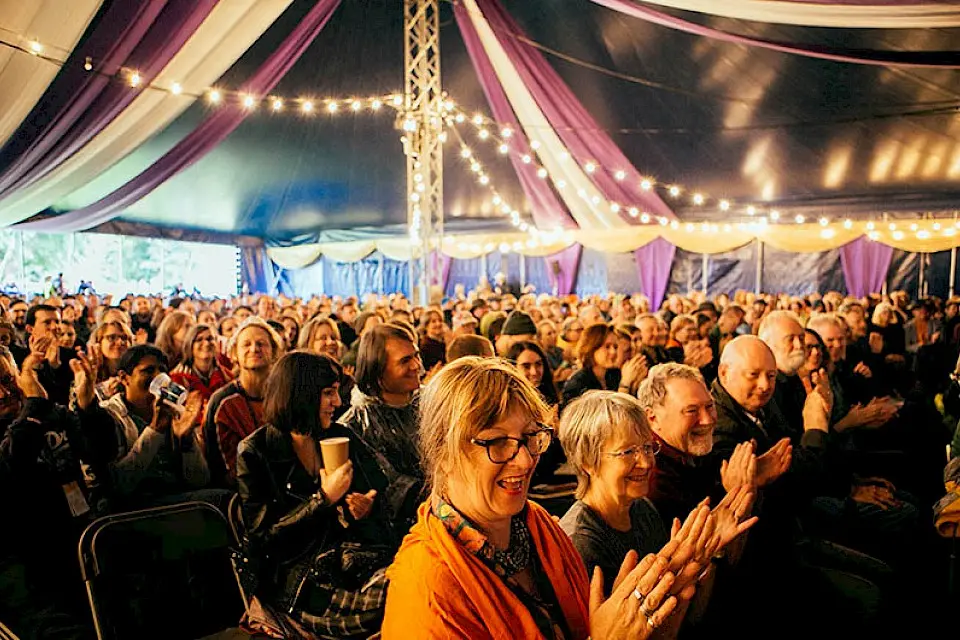 crowd in the babbling tongues tent clapping