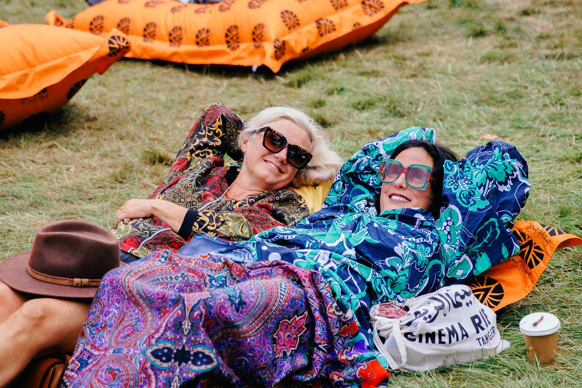 two women recline on a bean bag