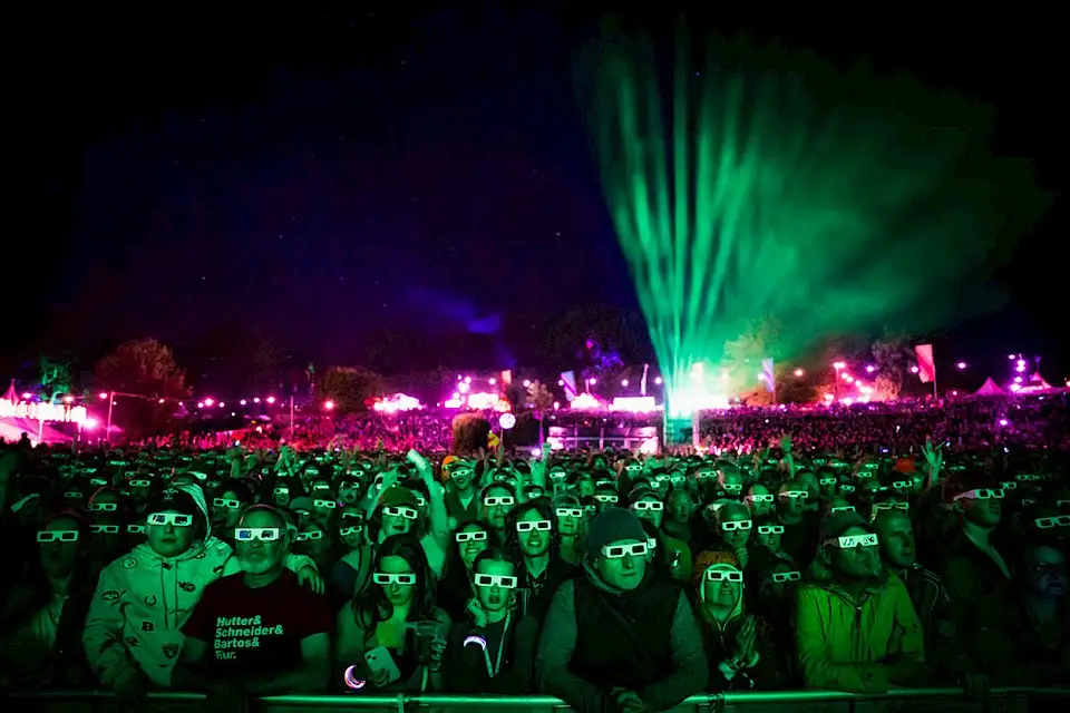 Looking back at the crowd wearing 3D glasses at the Mountain's Foot stage at night