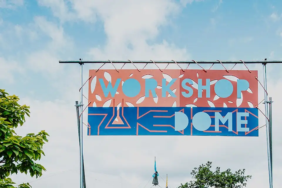 A large orange and blue sign reading 'Workshop Dome'
